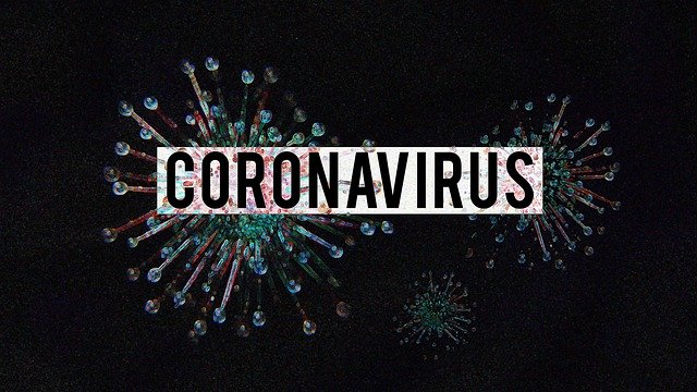 Word "Coronavirus" in front of virus particles